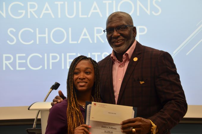 ILA President Vince Cameron presents a scholarship to a student