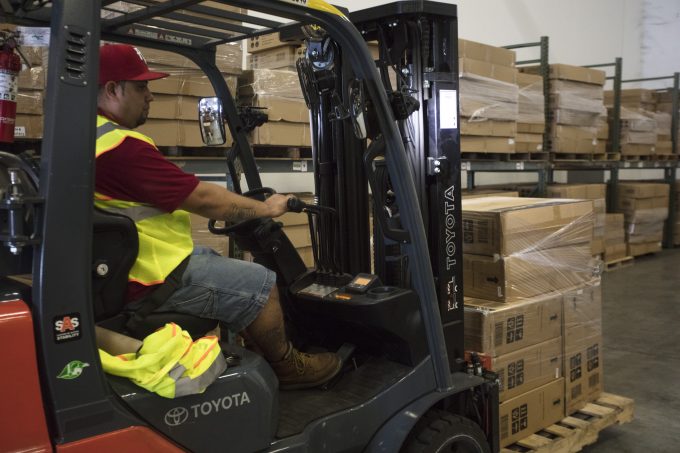 A worker at Shoreside moving cargo through the company's warehouse