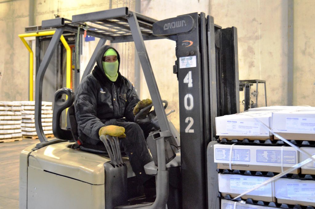 Worker on forklift moves product through the Seaonus Cold Storage warehouse. 