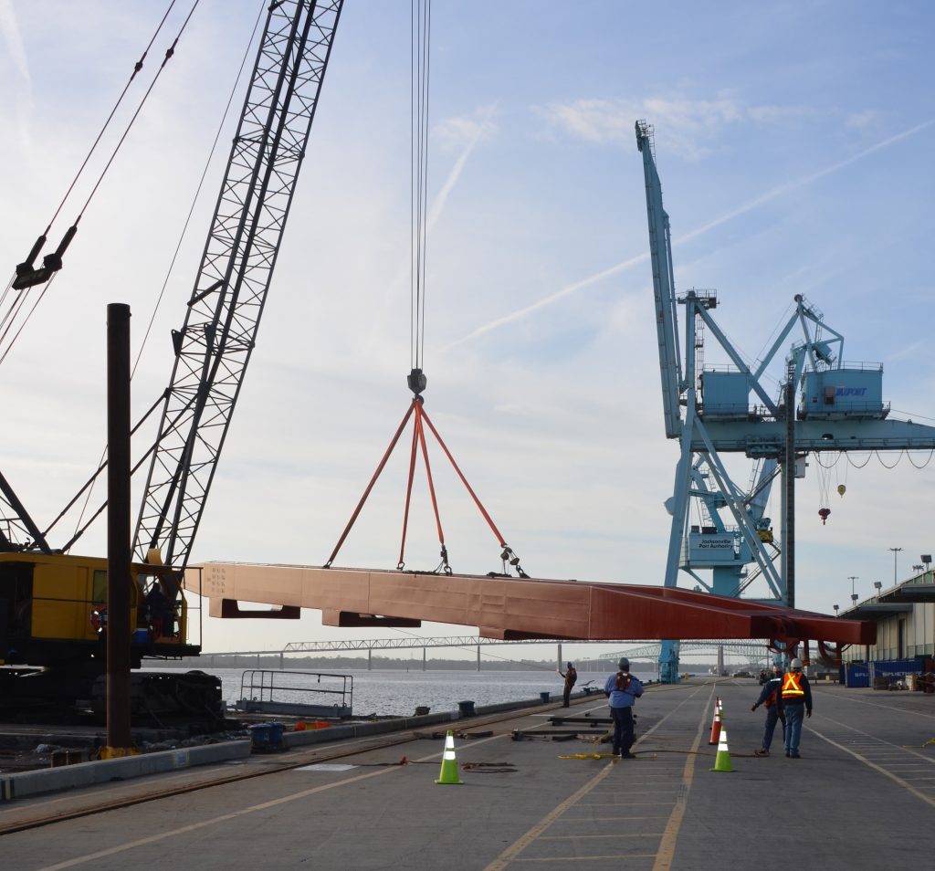 Large crane part being moved off a ship and onto the dock at JAXPORT"s Talleyrand Marine Terminal.